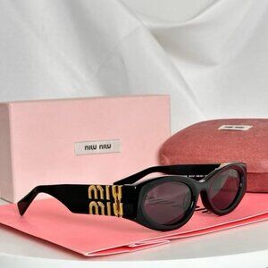 Miu Miu black sunglasses featuring elegant gold accents